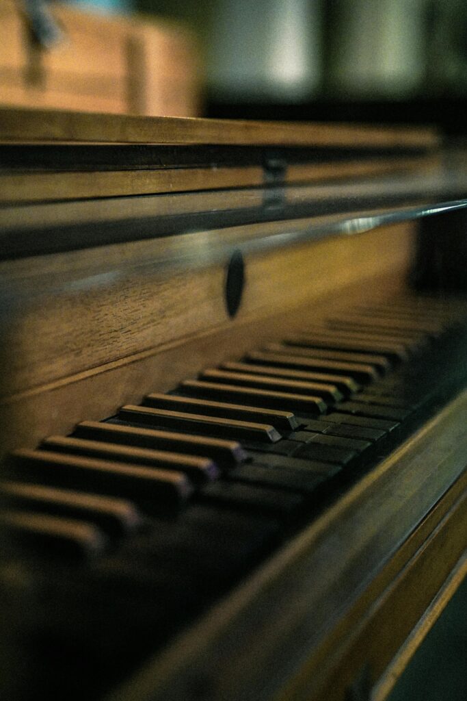 Elegant close-up of vintage piano keys, showcasing a nostalgic and moody atmosphere.